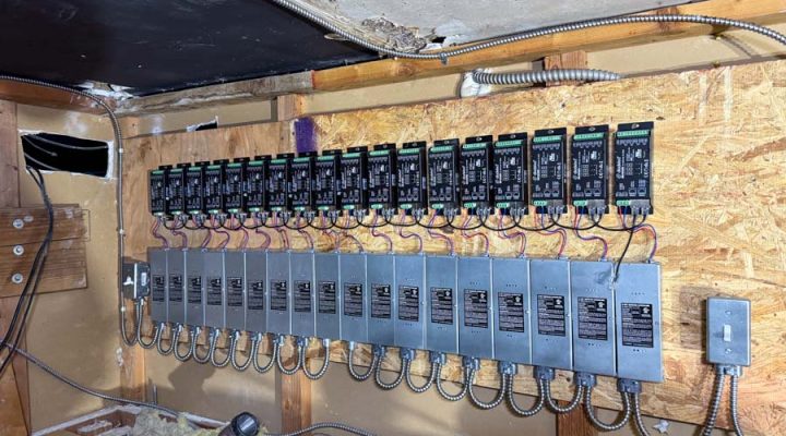 An extensive and neatly organized lighting control panel featuring multiple dimmers and drivers installed by Mizo Electric, designed to manage the dynamic lighting scenes of a large commercial space.