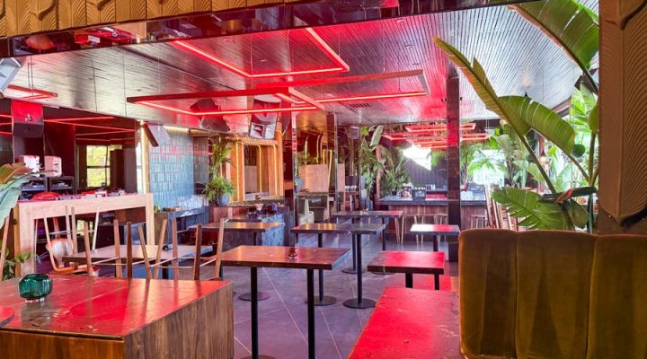 The striking interior of a restaurant at night, illuminated by custom red geometric LED light fixtures on the ceiling, designed and installed by Mizo Electric to create a unique and vibrant atmosphere for patrons.