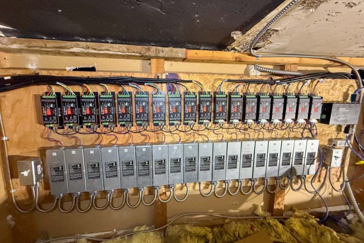 A sophisticated electrical control panel installed by Mizo Electric, featuring multiple relays and drivers for managing complex lighting or automation systems in a large commercial or industrial facility.