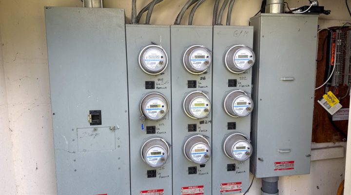An exterior wall-mounted electrical meter bank for a multi-unit property, highlighting Mizo Electric's capability to handle complex residential and commercial service upgrades and installations throughout San Diego.